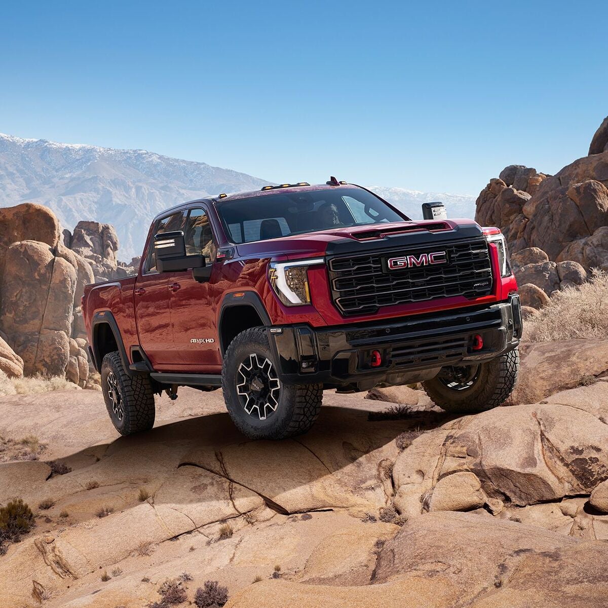 Front 3/4 shot of the 2025 GMC Sierra HD parked on rocky cliffside.